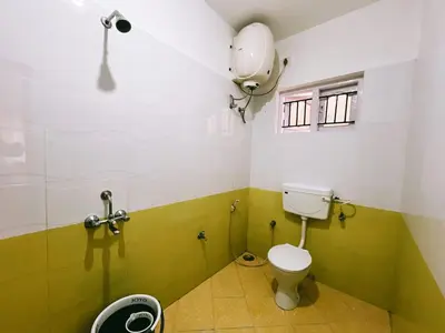 a small bathroom with a toilet and a shower at Hestia chalet 3BHK near Ooty lake in Ooty