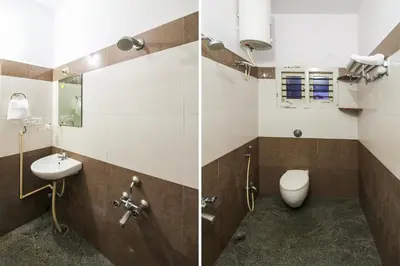 a bathroom with a toilet and a sink at Hotel O Kingston Residency in Vānivilāsa Puram