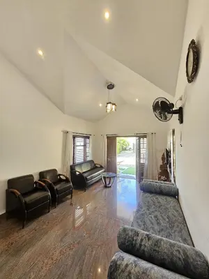 a living room with two couches and a couch at Serene Villa in Koroth