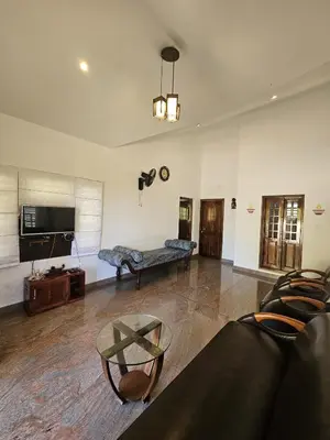 a living room with a couch and a table at Serene Villa in Koroth