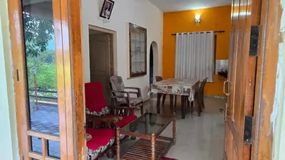 a room with a table and chairs and a dining room at Happy Home Stay in Palakkad