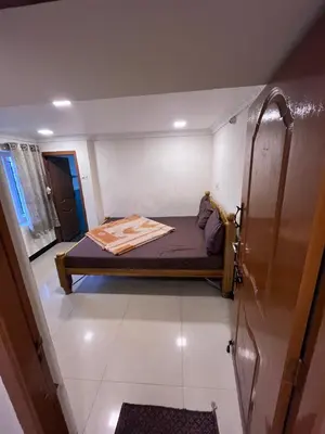 a small bedroom with a bed in a room at VR cottage in Ooty