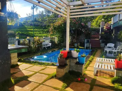 a backyard with a pergola and a swimming pool at Viharana Spa and Resorts in Ooty