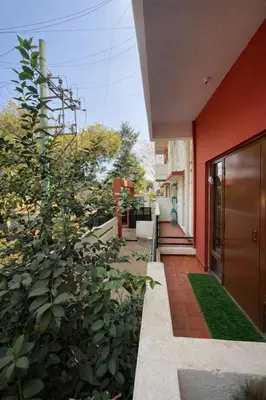 an external view of a house with a garden at Casa Mysuru Boulevard Stay Cozy 2BHK AC in Mysore