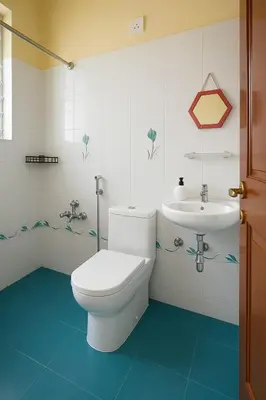 a bathroom with a toilet and a sink at Casa Mysuru Boulevard Stay Cozy 2BHK AC in Mysore