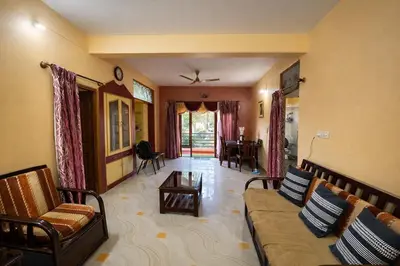 a living room with a couch and a table at Casa Mysuru Boulevard Stay Cozy 2BHK AC in Mysore