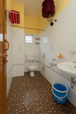 a bathroom with a toilet and a sink at Casa Mysuru Boulevard Stay Cozy 2BHK AC in Mysore