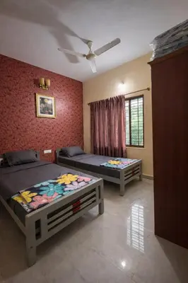 a bedroom with two beds and a ceiling at Casa Mysuru Boulevard Stay Cozy 2BHK AC in Mysore