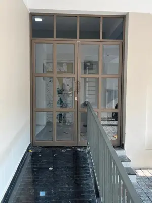 a large glass door with a staircase in a building at Serenity Homes near Rajagiri Hospital in Alwaye