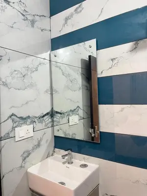 a bathroom with a sink and a mirror at Serenity Homes near Rajagiri Hospital in Alwaye