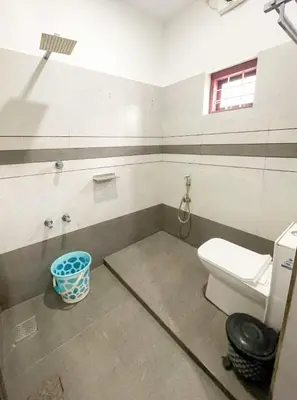 a bathroom with a toilet and a sink at Edakkal Pool Villa in Ambalavayal