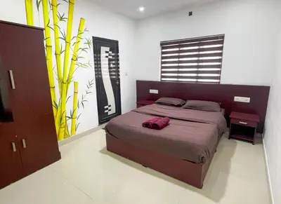 a bedroom with a large bed in a room at Edakkal Pool Villa in Ambalavayal