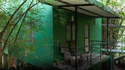 a green house with plants in front of it at Bamboo Planet Resort in Vythiri