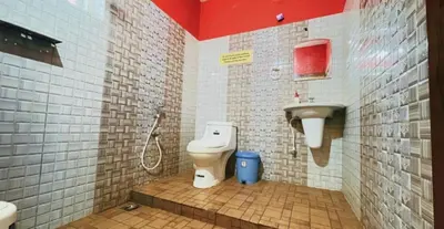 a bathroom with a toilet and a sink at Pepper Valley Resort in Kalpetta