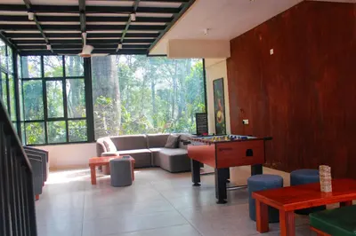 a living room with a couch and a table at Coorg Homes in Madikeri