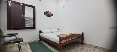 a small bedroom with a bed and a mirror at Krishna stays in Manattala