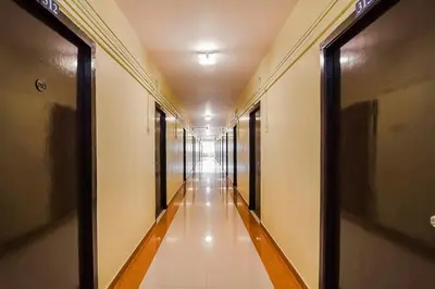 a corridor of a building with a long hallway at Super Hotel O By OYO Maruthi Gandhi Park in Coimbatore