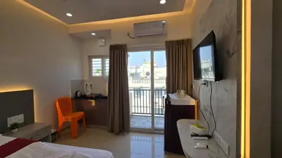 a hotel room with a bed and a balcony at Hi-Fi Service Apartment in Mysore