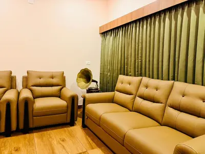 a living room with a couch and two chairs at Manayath Wayanad Premium Pool Resort in Wayanad