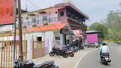 a group of motorcycles parked in front of a building at Thulir Homestay Valparai in Vālpārai