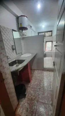 a bathroom with a sink and a mirror at Roshan Homestay in Madikeri