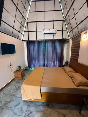 a bedroom with a large bed in a room at Zerahs Villa - Athirappilly - Extra upstair Bed space in Athirappilly