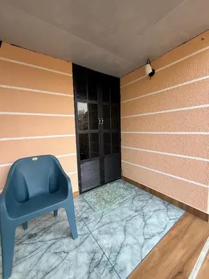 a blue chair in a room with a window at Zerahs Villa - Athirappilly - Extra upstair Bed space in Athirappilly
