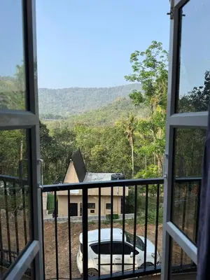 a view from the balcony of a house with a view at Zerahs Villa - Athirappilly - Extra upstair Bed space in Athirappilly