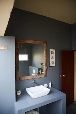 a bathroom with a sink and a mirror at House StoneHaven in Kaniyāmbetta