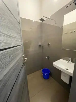 a bathroom with a sink and a mirror at Silver Gate Rooms in Kozhikode