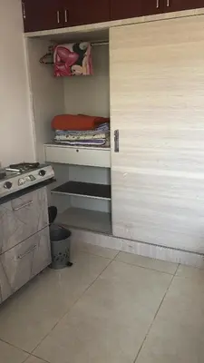 a kitchen with an open door to a kitchen with a stove at Free Private Room with Body Massage in Mysore