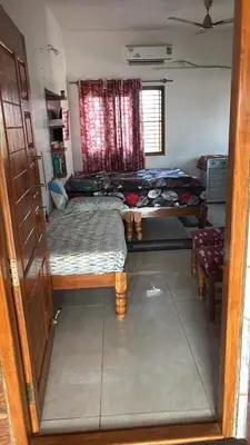 a small room with two beds and a window at Free Private Room with Body Massage in Mysore