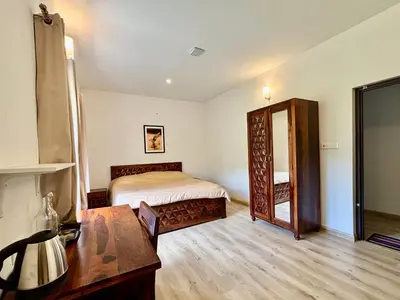 a bedroom with a bed and a large mirror at Easters home in Kotagiri