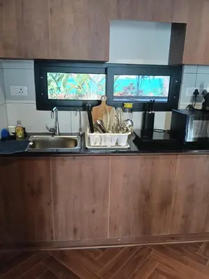 a kitchen with a sink and a counter top at Rajarajeshwari Farm Stay in Sivasamudram
