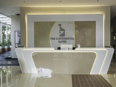 a lobby with a reception desk in a building at The Continental Suites in Kozhikode