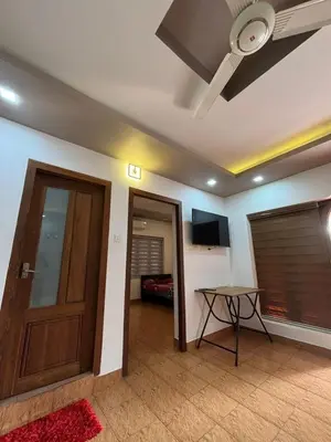 a room with a door and a table and a ceiling at Sawan Homestay in Tāzhekkod