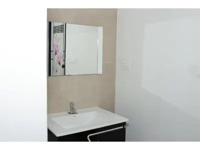 a bathroom with a white sink and a mirror at Angels Nest 3BR FF near Karlad Lake by Homeyhuts in Padinjarathara