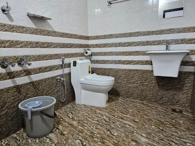a bathroom with a toilet and a sink at Guruvayur Nest Homestay Duo in Guruvāyūr