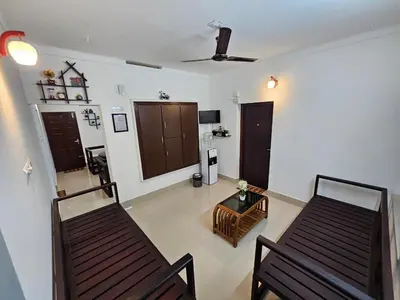 a living room with two chairs and a table at Guruvayur Nest Homestay Duo in Guruvāyūr
