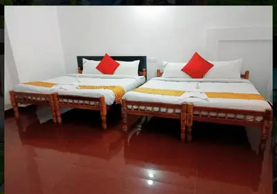 two beds sitting next to each other in a room at Nature Quite in Vattavada