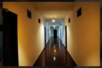 a hallway of a building with a long corridor at Nature Quite in Vattavada
