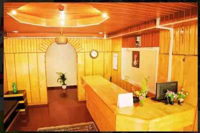 a room with wooden walls and a desk with a television at Nature Quite in Vattavada