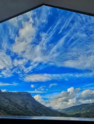 a window view of a blue sky with clouds at Canvo Vattavada in Vattavada