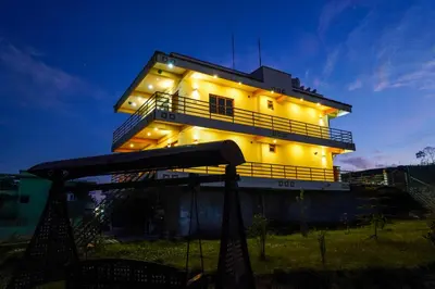 a building with lights on the side of it at Nature'call homestay in Ooty