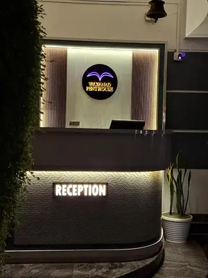 a reception desk with a reputation sign on it at Wayanad Pent House in Mananthavady