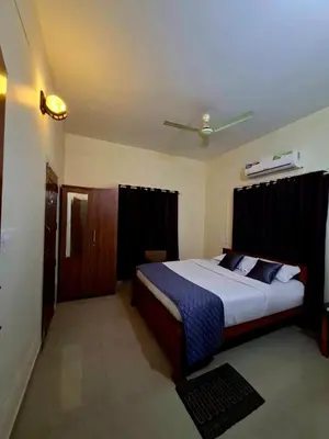 a bedroom with a large bed in a room at Wayanad Pent House in Mananthavady