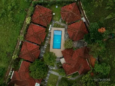 an overhead view of a house with a swimming pool at Misty Grove Resort, Gudalur in Devāla