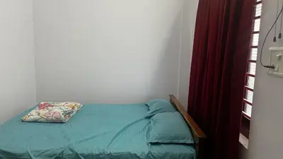 a bed with a pillow on it in a bedroom at Aneesh Arcade in Kollengode