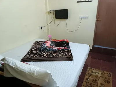 a blanket sitting on a bed in a room at Yamuna cottage in Ooty