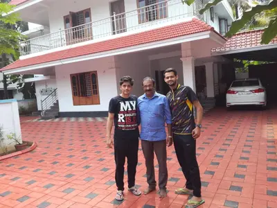 three men standing in front of a house at Grace Guest Home in Trichūr